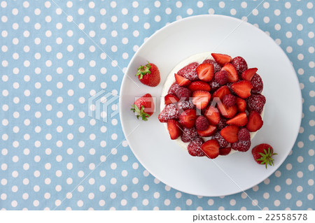 Berry cake on blue dotted background 22558578