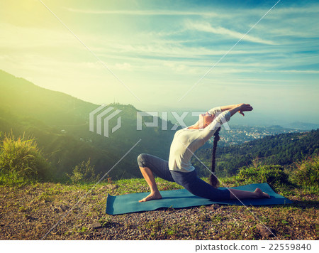 Sporty fit woman practices yoga Anjaneyasana in Sporty fit woman practices yoga Anjaneyasana in 22559840