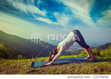 Young sporty fit woman doing yoga oudoors in 22559848
