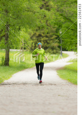 Sporty young female runner in city park.. Sporty young female runner in city park.. 22561453