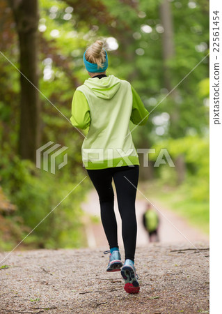 Sporty young female runner in the forest. Sporty young female runner in the forest. 22561454