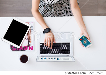 Pleasant woman sitting at the table  22562575