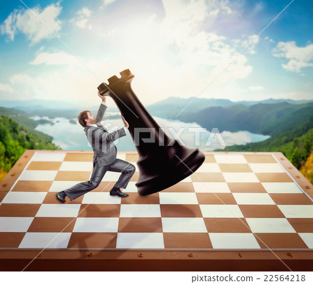 Businessman fighting with a chessman 22564218