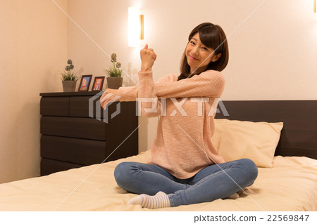 Stretching on the bed 22569847