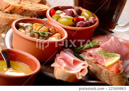Tapas of salmon mussels jamon and olives with beer 22569963