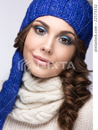 Beautiful girl with smile in blue knit hat. Beautiful girl with smile in blue knit hat. 22573332