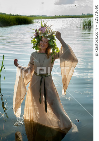 Beautiful sad woman with flower wreath Beautiful sad woman with flower wreath 22573660