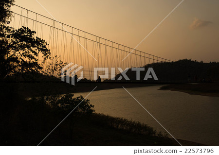 Silhouette rope bridge in the evening 22573796