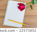 Red rose , notebook and pencil on wood background 22573852