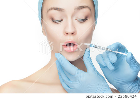 Attractive woman at plastic surgery with syringe Attractive woman at plastic surgery with syringe 22586424