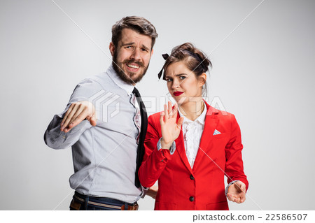 The business man and woman communicating on a gray 22586507