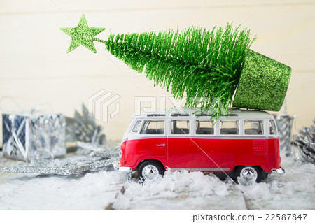Miniature red car with fir tree  22587847