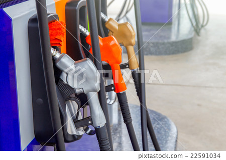 Gas pump nozzles in a service station Gas pump nozzles in a service station 22591034