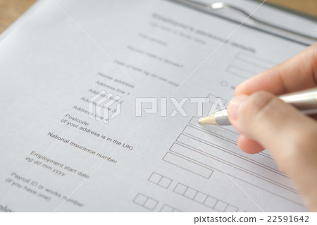 Hand with pen over application form 22591642