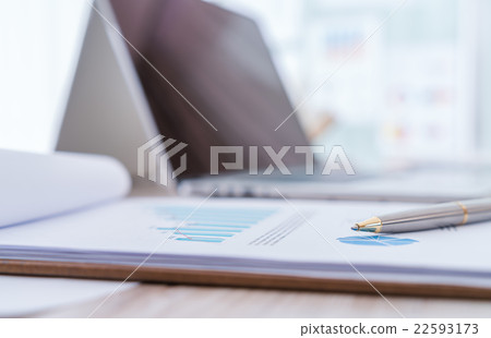 Financial charts on the table with laptop.. 22593173