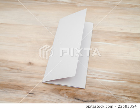 Trifold white template paper on wood texture.. 22593354