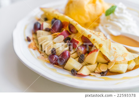 Pancake and fruit with ice cream on table 22593378