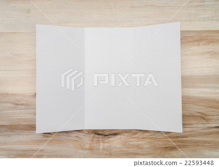 Trifold white template paper on wood texture.. 22593448