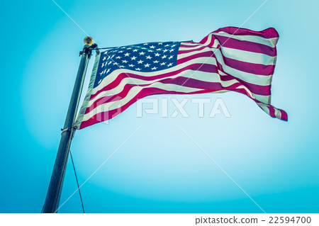 American flag on blue sky ( Filtered image processed vintage effect. ) American flag on blue sky ( Filtered image processed vintage effect. ) 22594700