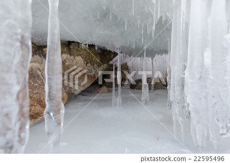Huge icicles on a cliff. 22595496
