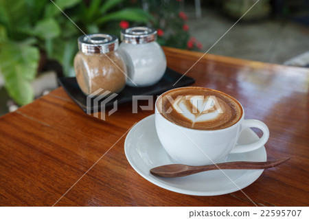 Cup of latte coffee on wooden table Cup of latte coffee on wooden table 22595707