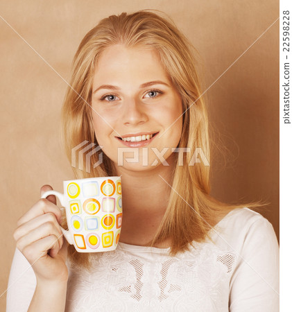 young cute blond girl drinking coffee close up on young cute blond girl drinking coffee close up on 22598228