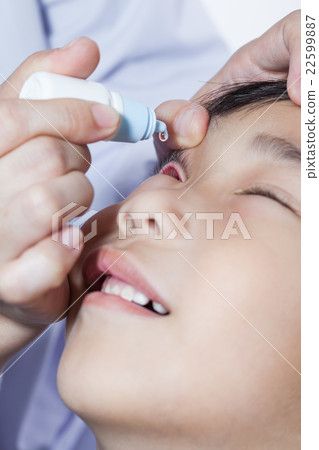 Doctor pouring eye drops in sick children Doctor pouring eye drops in sick children 22599887