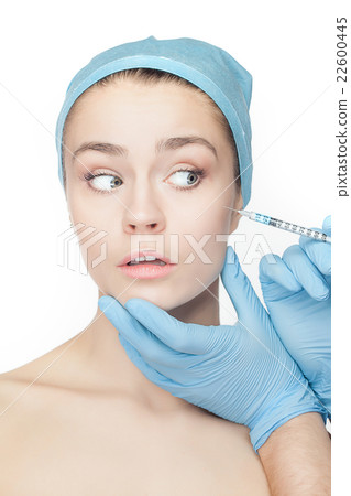 Attractive woman at plastic surgery with syringe Attractive woman at plastic surgery with syringe 22600445
