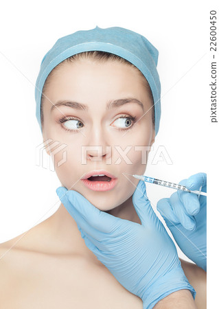 Attractive woman at plastic surgery with syringe Attractive woman at plastic surgery with syringe 22600450