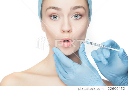 Attractive woman at plastic surgery with syringe Attractive woman at plastic surgery with syringe 22600452