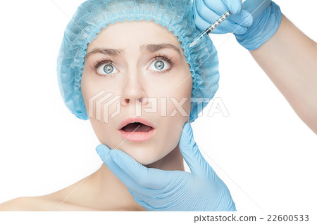 Attractive woman at plastic surgery with syringe Attractive woman at plastic surgery with syringe 22600533