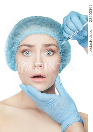 Attractive woman at plastic surgery with syringe Attractive woman at plastic surgery with syringe 22600562