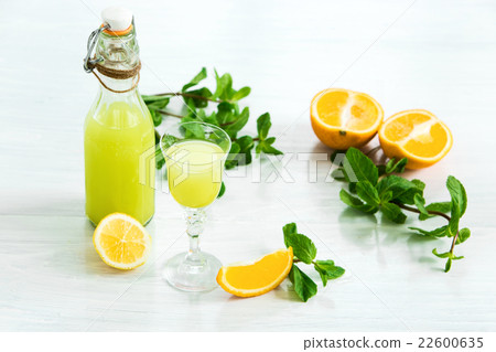 Home orange liquor in a glass and fresh oranges on Home orange liquor in a glass and fresh oranges on 22600635