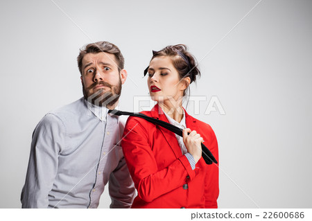 The business man and woman cooperating on a gray The business man and woman cooperating on a gray 22600686