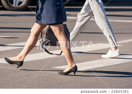 two pedestrians walking two pedestrians walking 22603161