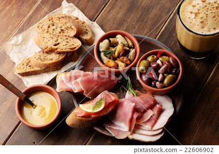 Tapas of salmon mussels jamon and olives with beer Tapas of salmon mussels jamon and olives with beer 22606902