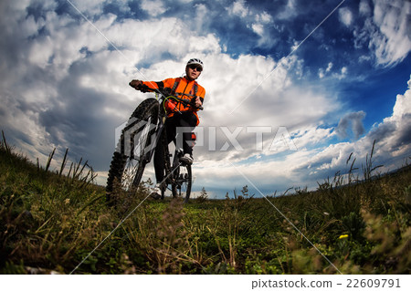 Young man travel by bicycle on rural road Young man travel by bicycle on rural road 22609791