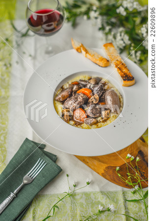 Beef bourguignon in a ceramic plate, tablecloth Beef bourguignon in a ceramic plate, tablecloth 22609896