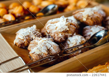 Croissants sprinkled with almonds, powdered suga 22617441