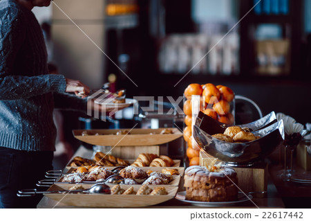 Assortment of fresh pastry on table in buffet 22617442