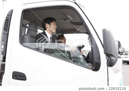Two men riding a truck Two men riding a truck 22618110