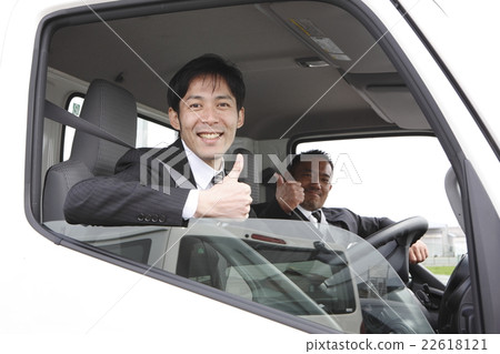 Two men riding a truck 22618121