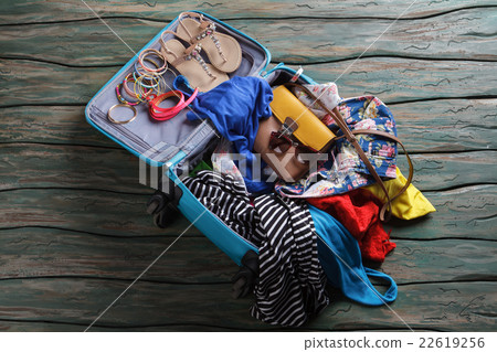 Opened suitcase with crumpled clothes. Opened suitcase with crumpled clothes. 22619256