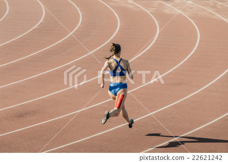 girl sprinter runs through stadium girl sprinter runs through stadium 22621242
