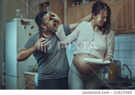 Husband and wife fighting in the kitchen. 22623984