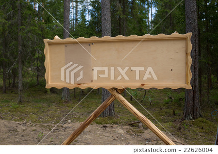 Wooden frame for a sign against the forest. 22626004