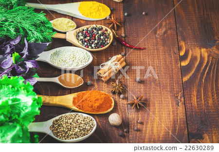 Beautiful colorful spices in wooden spoons 22630289