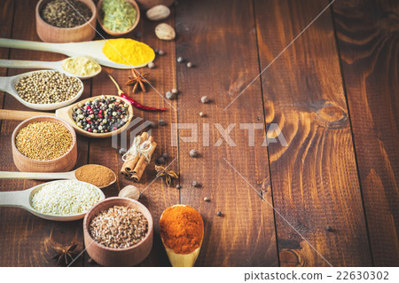 Beautiful colorful spices in wooden spoons  22630302
