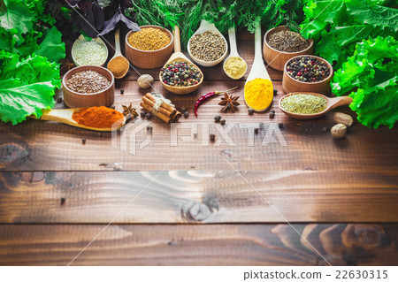 Beautiful colorful spices in wooden spoons  22630315