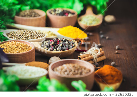 Beautiful colorful spices in wooden spoons  22630323